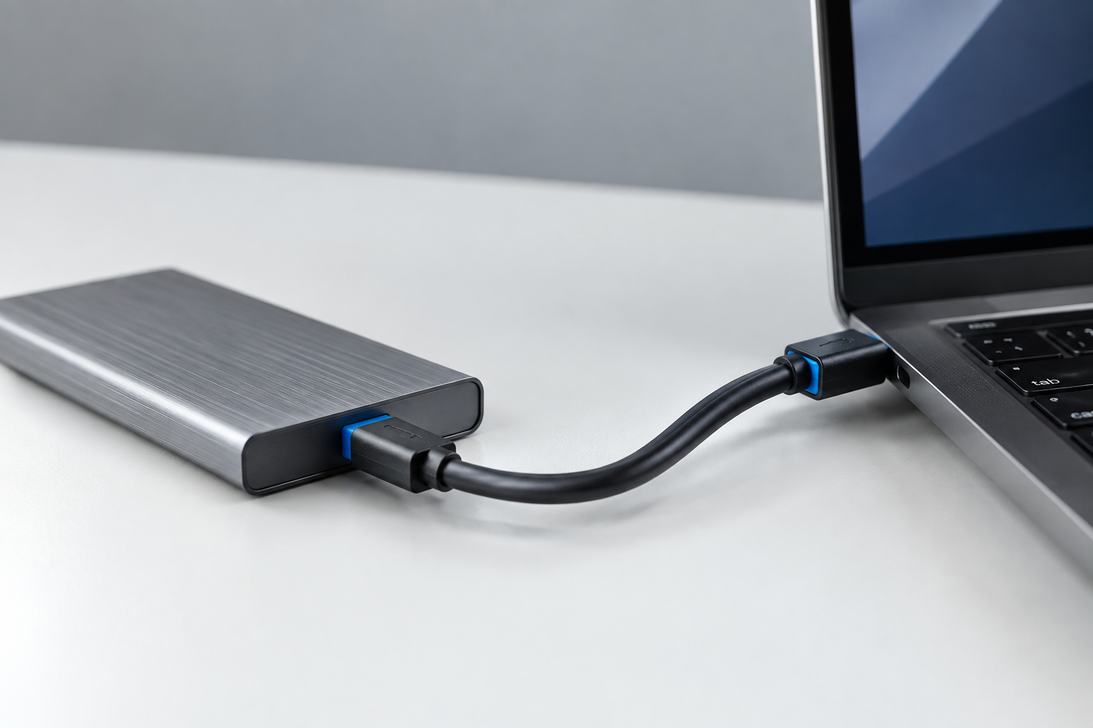 External SSD connected via USB 3.2 Gen 1 blue USB-A cable representing 5 Gbps speed